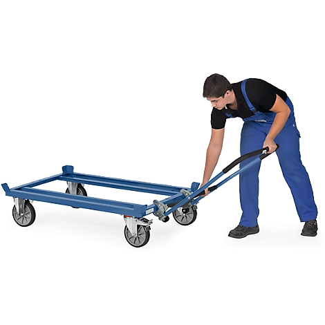 A man in blue overalls pulls a blue transport cart with wheels.