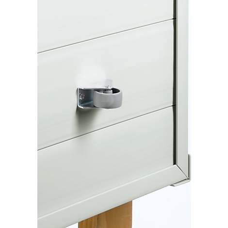 Grey furniture knob on a white painted drawer. The drawer is made of wood.