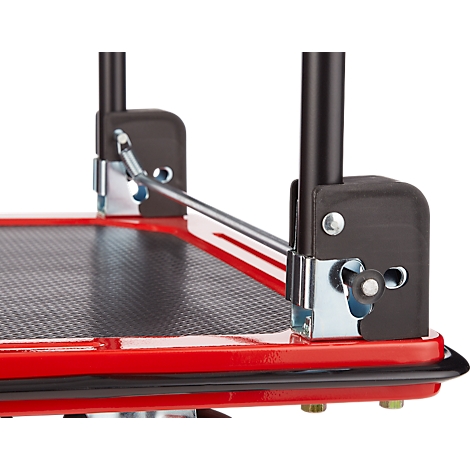 Close-up van een rood platform met zwarte handvatten. Details zoals schroeven, hoeken en metalen verbindingen zijn zichtbaar.