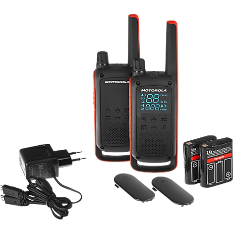 Two black radios with red trim, accessories such as charger, covers and batteries. The display shows a digital display.