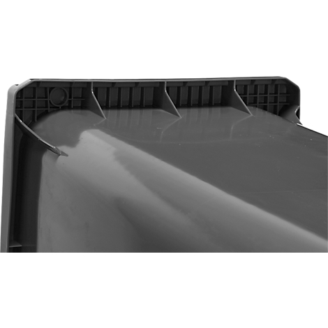 Gros plan d'une surface en plastique sombre avec des nervures de renfort et de petites ouvertures.