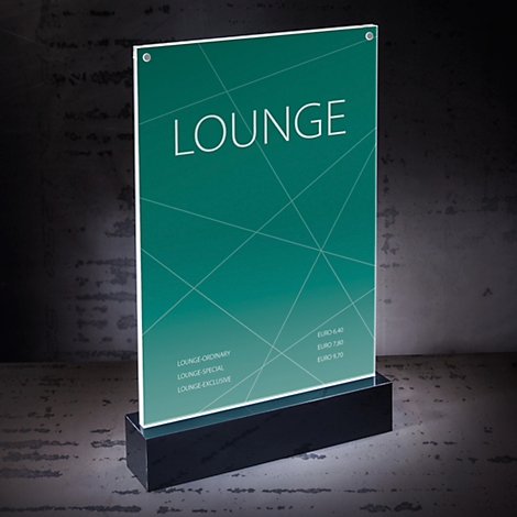 Illuminated sign with “LOUNGE” text, on a black base against a gray background.