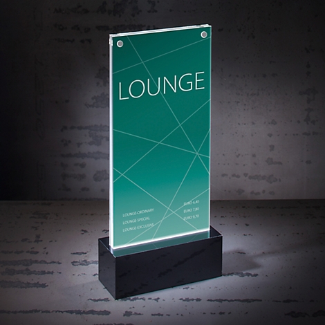 Illuminated lounge sign with text and green background, standing on a black base.