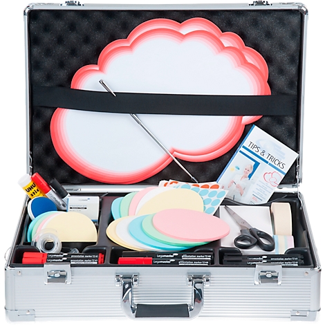 Open silver suitcase with creative accessories: cloud board, colored papers, pens, scissors, tape, instruction booklet.