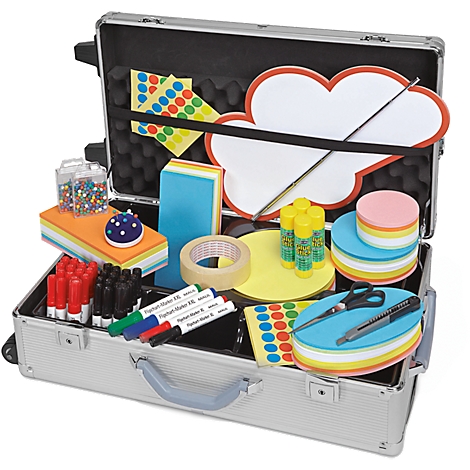 Opened silver case filled with school supplies, including felt-tip pens, glue sticks, notepaper and scissors.