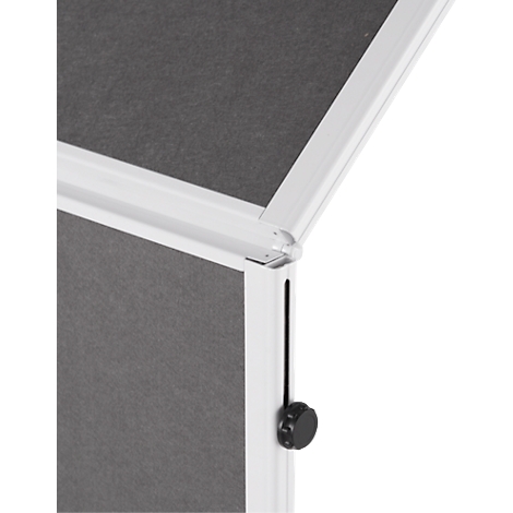 Close-up of a white, rectangular object with a gray surface and black knob.