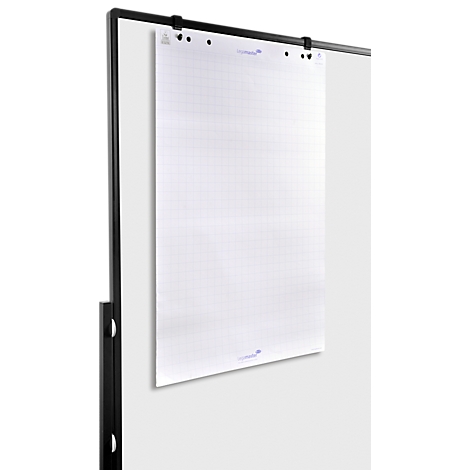 A white, grid-lined flip chart paper is attached to a black metal holder, hanging against a gray wall.