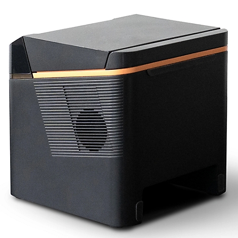 Schwarzer, quaderförmiger Gerät, mit kupferfarbenem Akzent. Seitlich Lüftungsschlitze und runde Öffnung.