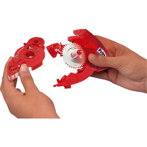 Hands holding a red adhesive tape device, disassembled into parts.