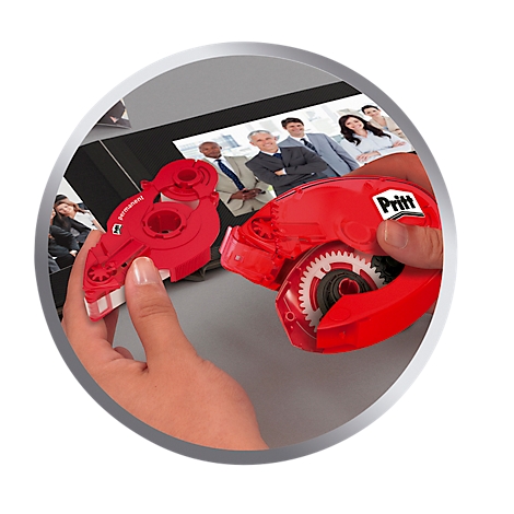 Person holding red Pritt glue roller. In the background is a photo of people in suits.
