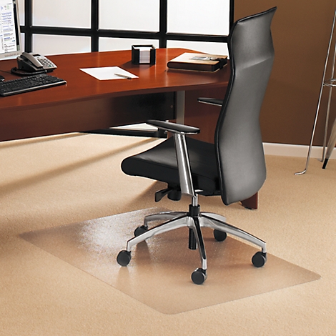 Office chair with mat in front of desk. The carpet is beige, the mat is transparent.