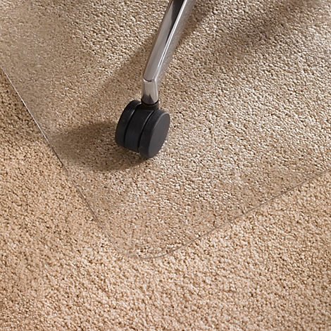 Transparent office chair mat on beige carpet. A chair leg with a roller is visible.