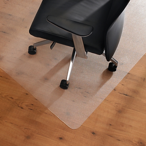 Office chair on a transparent floor protection mat on a wooden floor.
