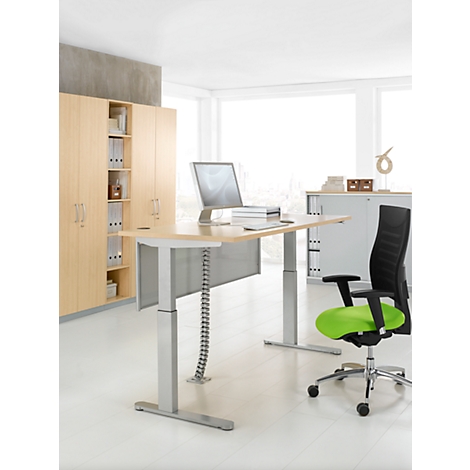 Bright office desk with silver legs, monitor and chair. Cabinet and window in the background.