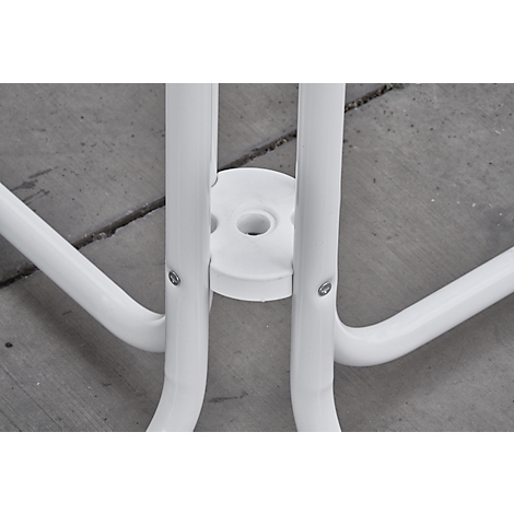 Detail of white chair leg connection. Round tubes and a white disc with screws.