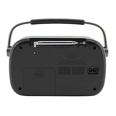 Vue arrière d'une radio rétro sombre. Avec antenne, poignée de transport et connecteur d'alimentation.