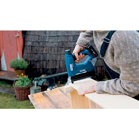 Person using a blue stapler. Wood being processed.