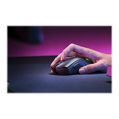 Hand, die eine graue Gaming-Maus auf schwarzem Mousepad bedient, Hintergrund pink.