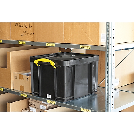 Black box with yellow handles on a metal shelf, surrounded by cardboard boxes and labels.