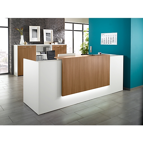 Modern reception desk in white and wood look with lighting. Office with cabinet wall in the background.