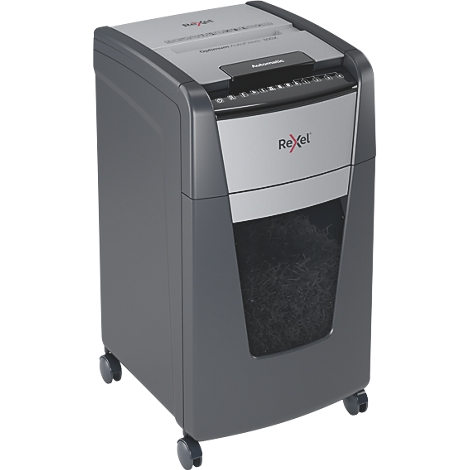 Grey paper shredder with wheels. The Rexel logo is clearly visible. The collection bin is half full of shredded paper.