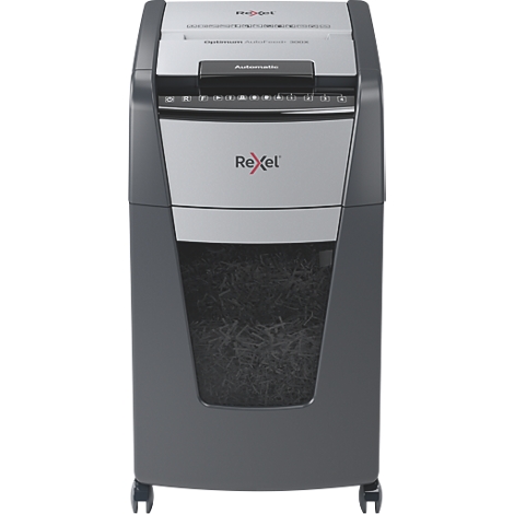 Gray paper shredder. Rexel logo. Inscription: Automatic. Paper in collection container.