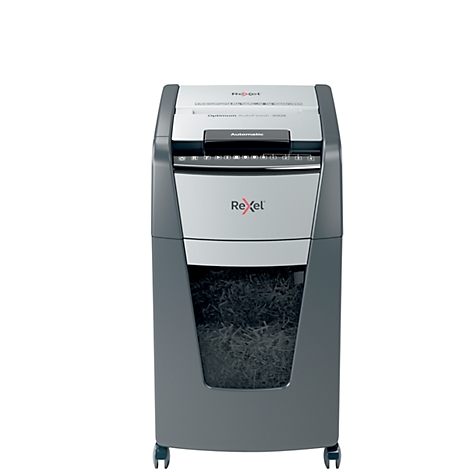 Gray and silver paper shredder with Rexel logo, filled paper waste container. The device stands on castors.