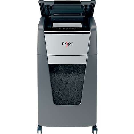 Gray paper shredder, paper is visible in the collection container. The lid is open. The Rexel logo is visible.