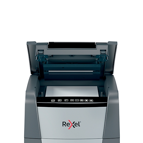 A grey paper shredder with the lid open, revealing a white sheet of paper. The Rexel logo is visible.
