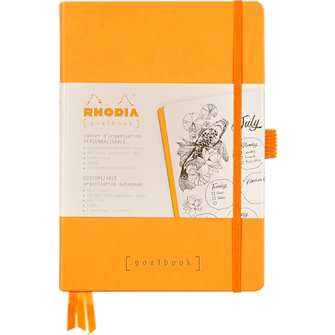 Cahier orange avec élastique et marque-page, enveloppé dans du papier imprimé. Impressions : Rhodia, Goalbook.