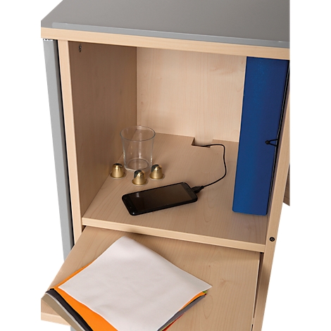 Open cabinet with content: glass, golden bells, smartphone, file folder and paper.