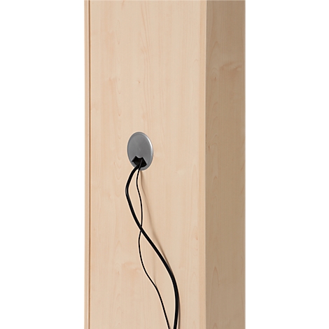 Close-up of light wood surface with a gray cable grommet from which black cables protrude.