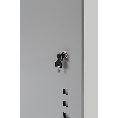 Gray metal door with keyhole and two keys. Three square recesses are visible below.