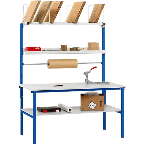 Packing table with blue frame, wooden boards, cardboard and tools. Top level with boards, rolls and tools. A paper roll at the middle level.