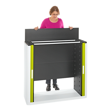A woman behind a white, black, and green presentation lectern. She is holding the top of the lectern.