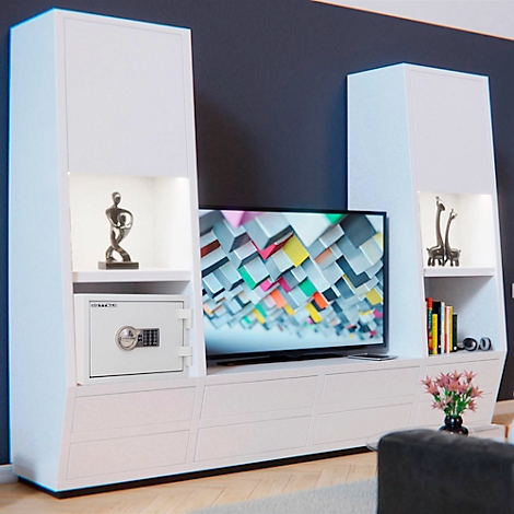 Modern white living room wall unit with TV, safe, and decoration. TV displays colorful blocks. Sculpture, books, and figure on the sides.