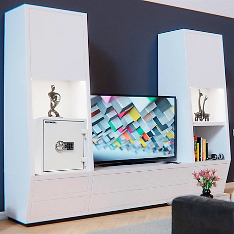 White living room wall unit with integrated safe, TV, and decorative items.