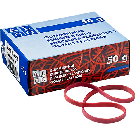 Box of red rubber bands next to some loose bands. Label: GUMMIRINGE, Rubber Bands.