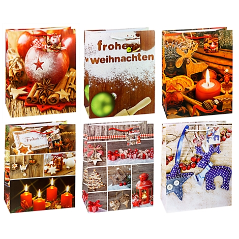 Différents sacs cadeaux de Noël avec des motifs de Noël. Inscription : Joyeux Noël.