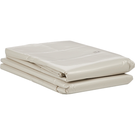 Drap de lit beige plié reposant sur une surface.