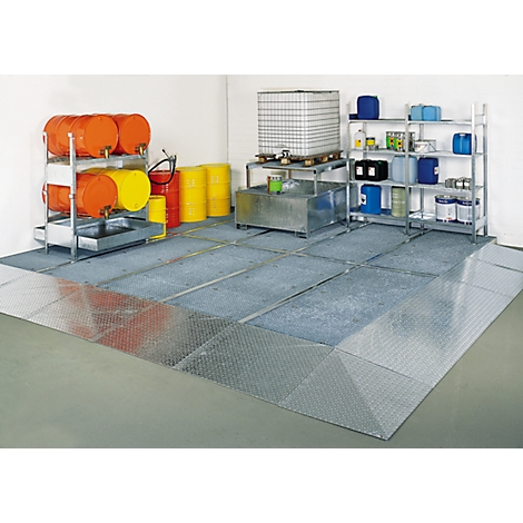 Metal floor with barrels, tanks and shelves in a warehouse. Protection against leaking liquids.