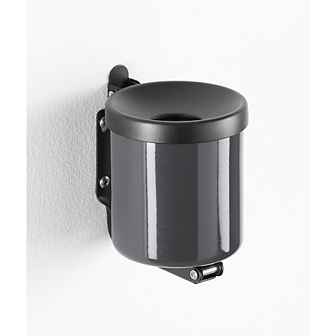 Gray wall-mounted ashtray with round lid and black holder. It's attached to a white wall.