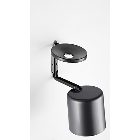 Black wall lamp with a round lampshade and a cylindrical housing, mounted on a white wall.