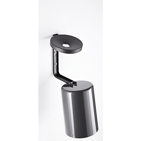 A metal wall mount, with a cylindrical container and a round shelf, attached to the wall.