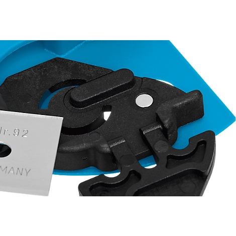 Close-up of black plastic parts with a silver blade. "Nr.92" and "GERMANY" are written on the blade.