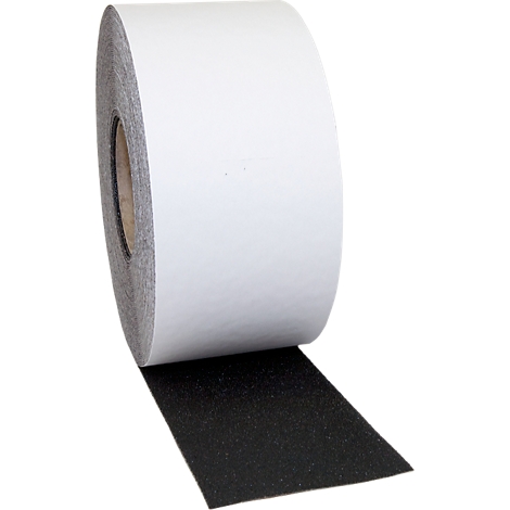 Roll of white adhesive tape with a black adhesive surface. Detailed shot of an adhesive tape.