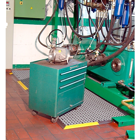 Green toolbox with wheels and mounted machine. In the background another machine and pipes.