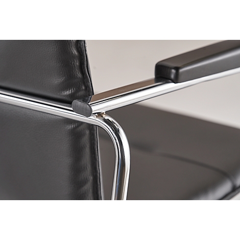 Close-up of a black leather chair, chrome armrest.