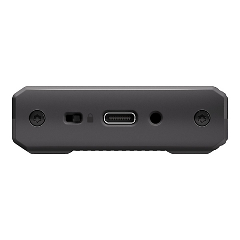 Nahaufnahme der schwarzen Oberseite eines elektronischen Geräts mit Anschlüssen und Schrauben.