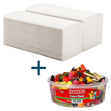 Deux serviettes en papier blanches à côté d'un bol de bonbons gélifiés Haribo colorés.